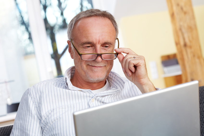 mature man with laptop and eyeglasses